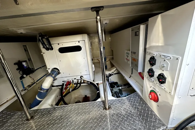 Slide: The Image of Engine room of 2014 Marquis 420 Sport Bridge with electrical panels and piping. - 48