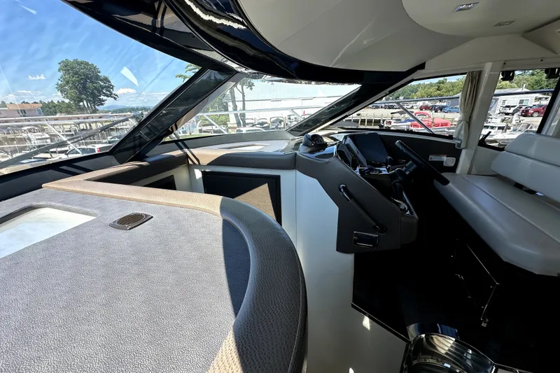 Slide: The Image of Interior view of 2014 Marquis 420 Sport Bridge yacht cockpit with modern controls and seating. - 33