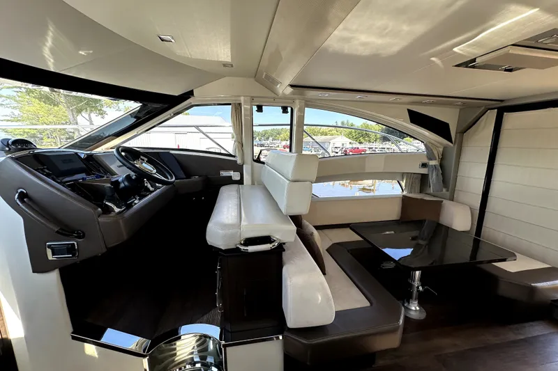 Slide: The Image of Luxurious interior of a 2014 Marquis 420 Sport Bridge yacht with modern seating and helm. - 28