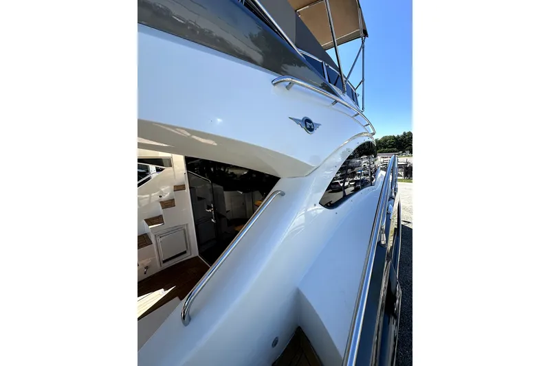 Slide: The Image of 2014 Marquis 420 Sport Bridge yacht, sleek design with polished railings and spacious deck. - 18
