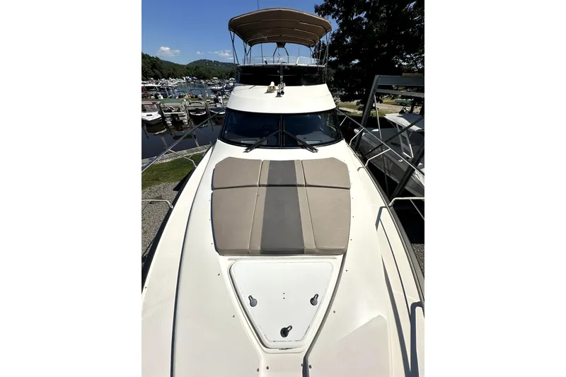 The Image of 2014 Marquis 420 Sport Bridge yacht docked, featuring spacious deck and sleek design. - 15