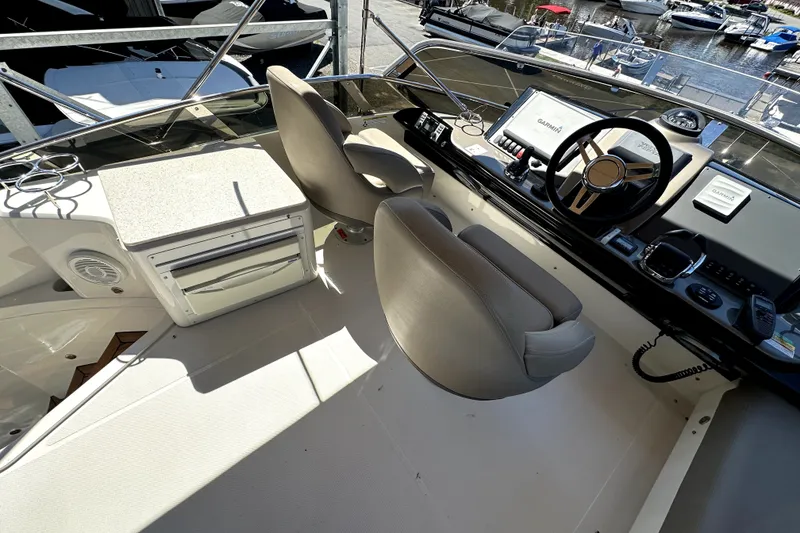 Slide: The Image of Helm of 2014 Marquis 420 Sport Bridge with dual seats and navigation equipment. - 19