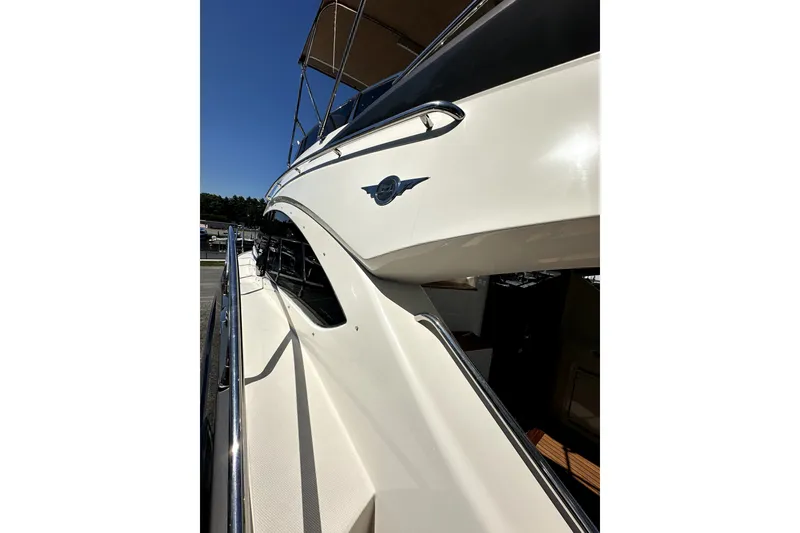 Slide: The Image of 2014 Marquis 420 Sport Bridge yacht, sleek white exterior, chrome accents, sunny day. - 17