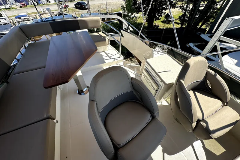 Slide: The Image of Flybridge of 2014 Marquis 420 Sport Bridge with seating, table, and helm chairs. - 31