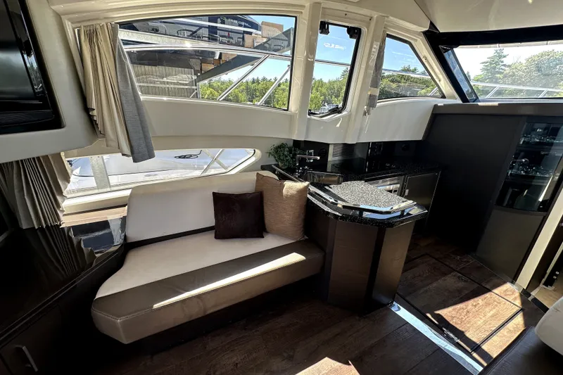 Slide: The Image of Luxurious interior of a 2014 Marquis 420 Sport Bridge yacht with elegant seating and modern design. - 26