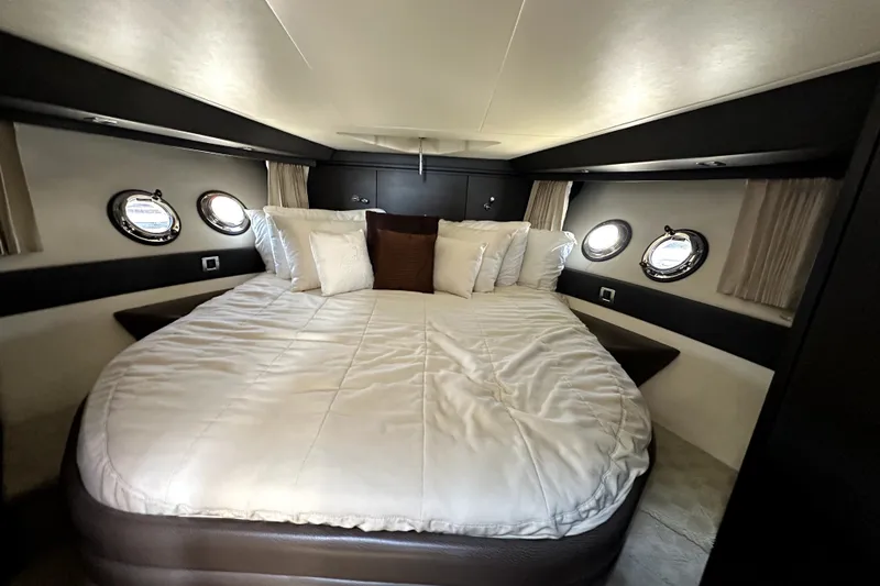 Slide: The Image of Luxurious bedroom interior of 2014 Marquis 420 Sport Bridge yacht with porthole windows. - 35