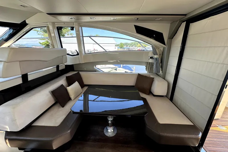 Slide: The Image of Luxurious interior of 2014 Marquis 420 Sport Bridge yacht with elegant seating and table. - 25