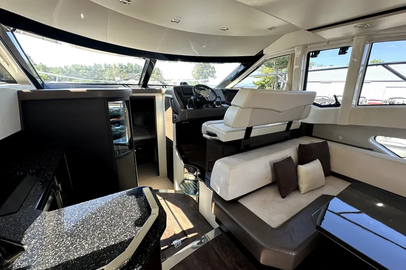 Slide: The Image of Luxurious interior of 2014 Marquis 420 Sport Bridge yacht with modern seating and helm. - 29