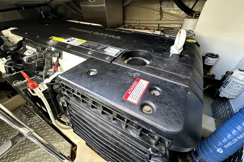 Slide: The Image of Engine compartment of a 2014 Marquis 420 Sport Bridge yacht, showcasing detailed components. - 46