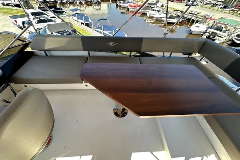 Slide: The Image of Luxurious seating area on a 2014 Marquis 420 Sport Bridge yacht with wooden table. - 21