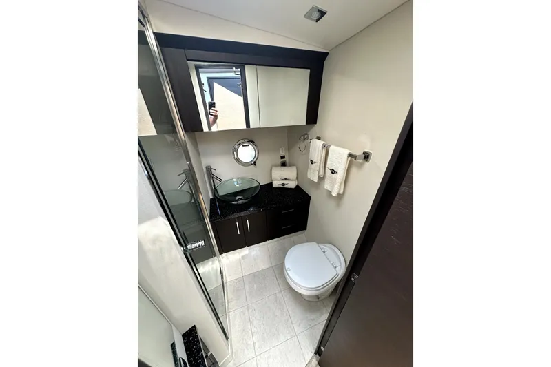 Slide: The Image of Luxurious bathroom in 2014 Marquis 420 Sport Bridge yacht with modern fixtures and elegant design. - 39