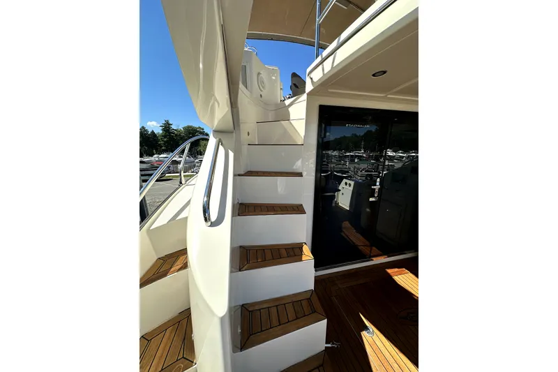 Slide: The Image of Staircase on 2014 Marquis 420 Sport Bridge yacht with teak decking and sleek design. - 20