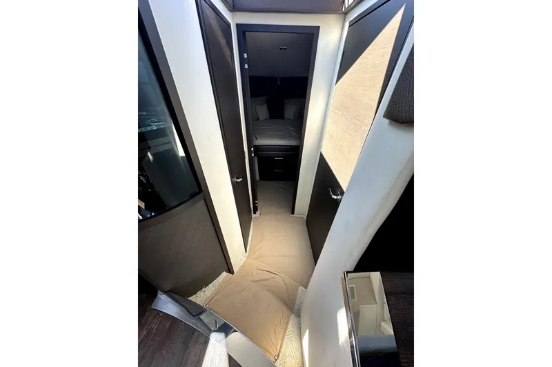 Slide: The Image of Interior hallway of 2014 Marquis 420 Sport Bridge yacht, featuring modern design and cozy bedroom. - 32