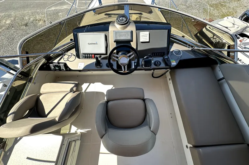 Slide: The Image of 2014 Marquis 420 Sport Bridge helm with Garmin navigation, steering wheel, and seating. - 22