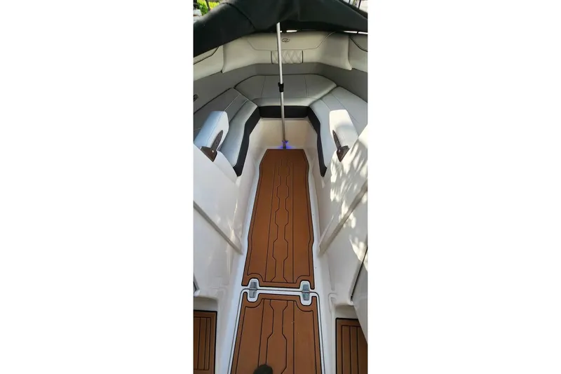 Slide: The Image of 2022 Regal LS2 boat interior with teak-style flooring and cushioned seating. - 10