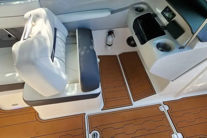 Slide: The Image of 2022 Regal LS2 boat interior with white seating, teak flooring, and cup holders. - 8