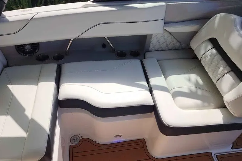 Slide: The Image of Luxurious seating in 2022 Regal LS2 boat with white upholstery and cup holders. - 12