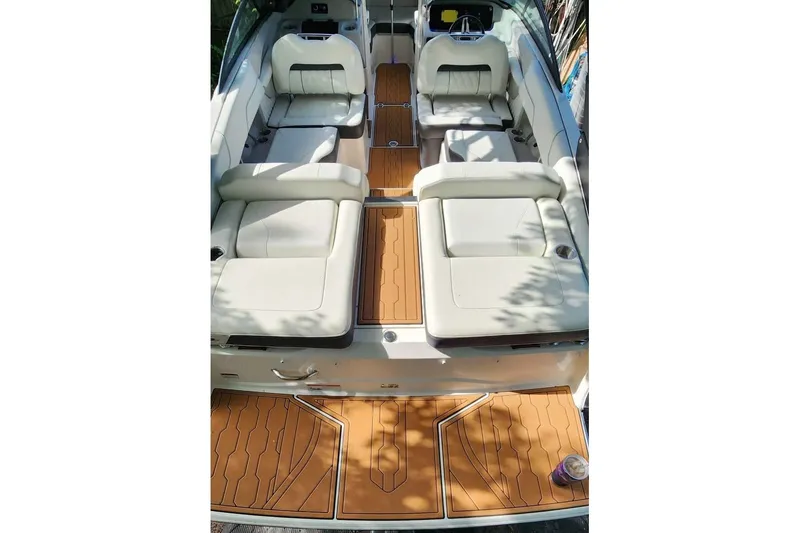 Slide: The Image of 2022 Regal LS2 boat interior with white seating and teak-style flooring. - 11