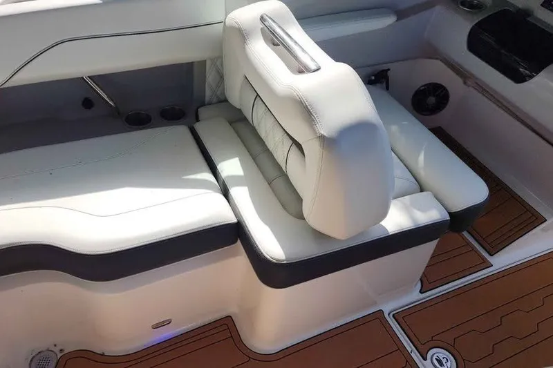 Slide: The Image of Luxurious seating in 2022 Regal LS2 boat with white upholstery and wood accents. - 9