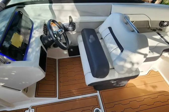 Slide: The Image of 2022 Regal LS2 boat interior with modern dashboard and comfortable seating. - 5