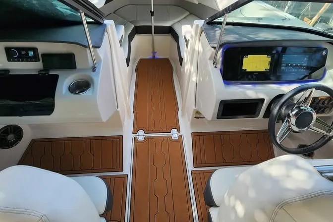 Slide: The Image of 2022 Regal LS2 boat interior with modern dashboard and teak-style flooring. - 13