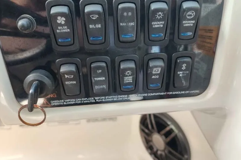 Slide: The Image of Control panel of a 2022 Regal LS2 boat with various switches and key ignition. - 16
