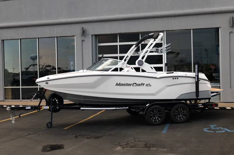 Slide: The Image of 2027 MasterCraft NXT20 boat on trailer outside dealership. - 3