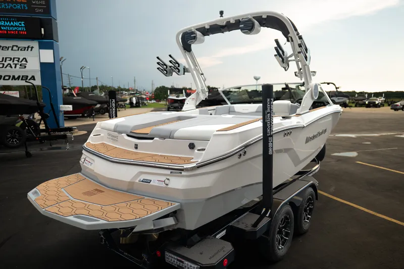 Slide: The Image of 2027 MasterCraft NXT20 boat on trailer at dealership, showcasing sleek design and modern features. - 10