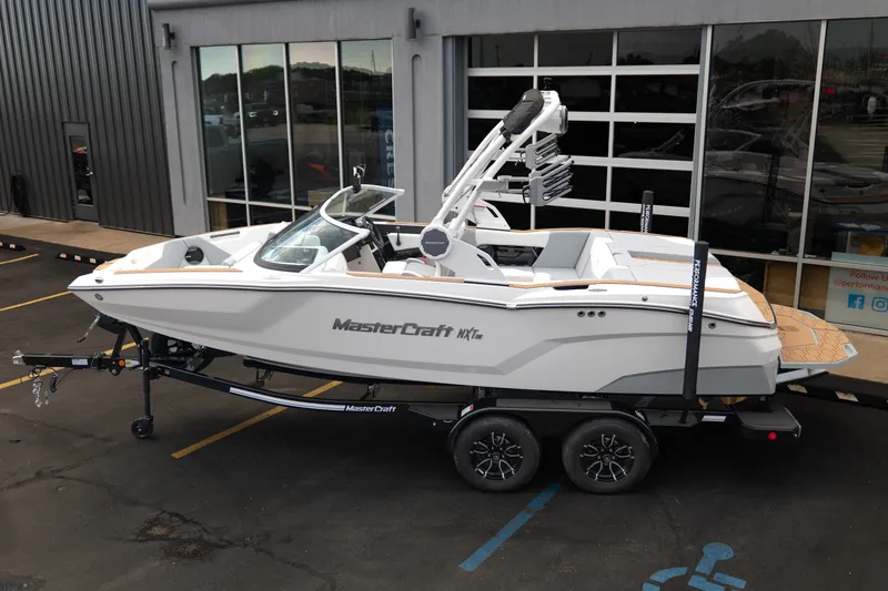 Slide: The Image of 2027 MasterCraft NXT20 boat on trailer outside showroom. - 5