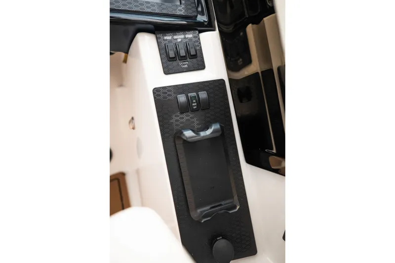 Slide: The Image of Control panel of 2027 MasterCraft NXT20 boat with sleek black design and switches. - 45