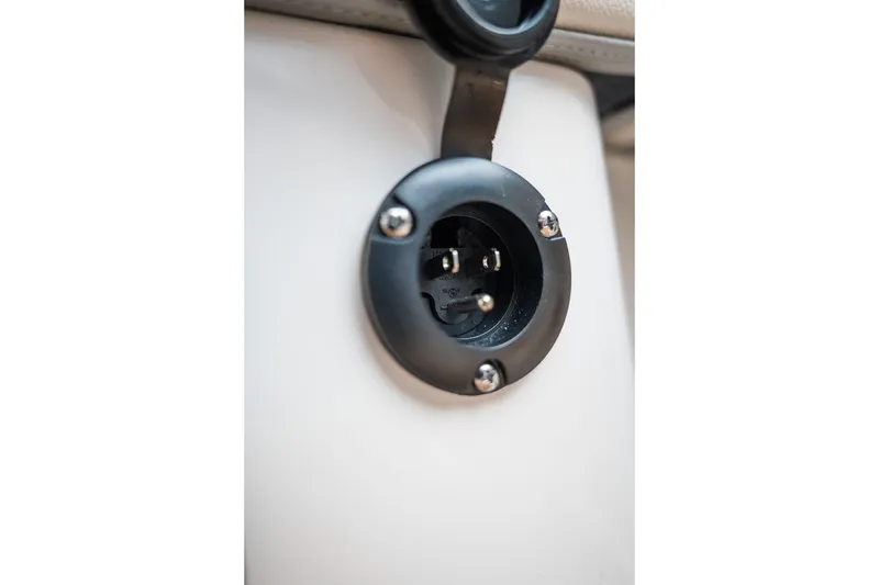 Slide: The Image of Close-up of a 2027 MasterCraft NXT20 boat's electrical socket detail. - 43