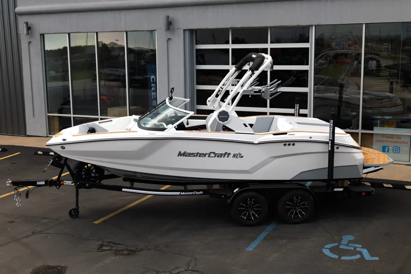 Slide: The Image of 2027 MasterCraft NXT20 boat on trailer outside showroom. - 4