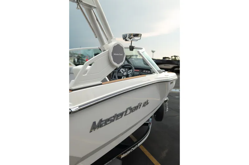 Slide: The Image of 2027 MasterCraft NXT20 boat, side view with branding and sleek design. - 11