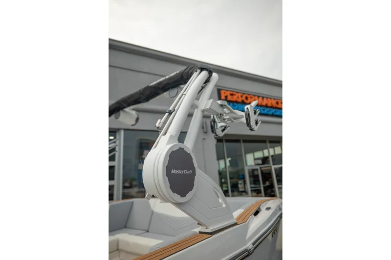 Slide: The Image of 2027 MasterCraft NXT20 boat with wakeboard tower, displayed outside a dealership. - 18