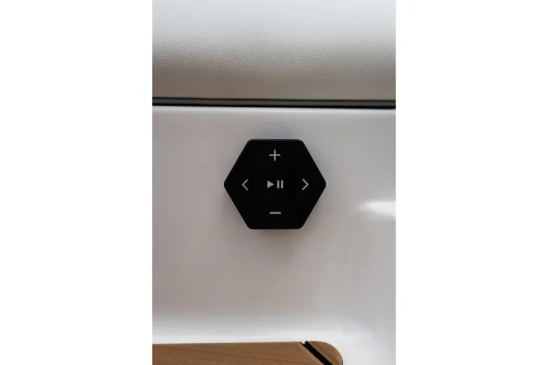 Slide: The Image of Control panel on 2027 MasterCraft NXT20 boat, featuring play and volume buttons. - 22