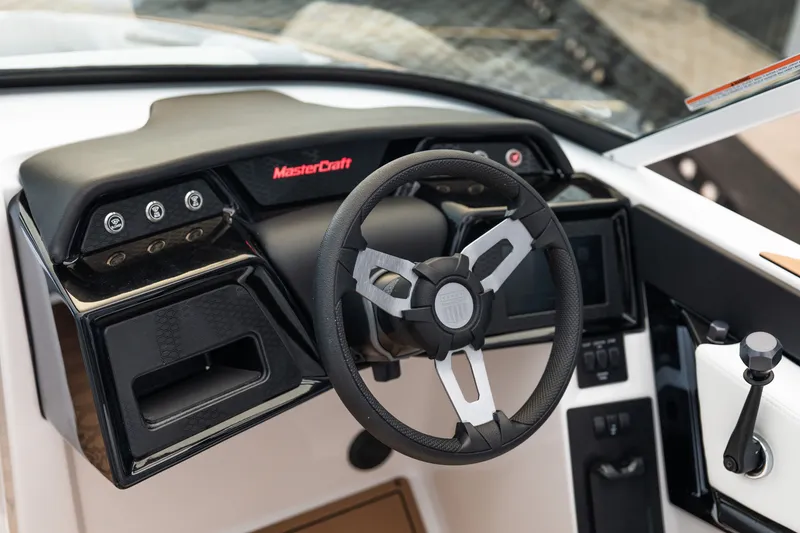 Slide: The Image of 2027 MasterCraft NXT20 boat dashboard with steering wheel and control panel. - 36