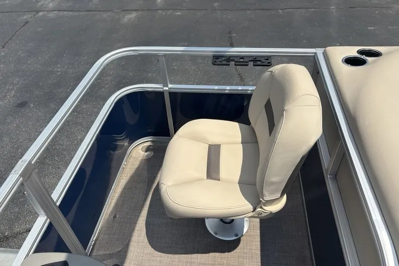 Slide: The Image of 2024 Sun Tracker Bass Buggy 18 DLX boat seat, beige upholstery, cup holders visible. - 24