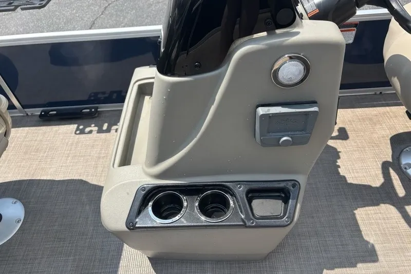 Slide: The Image of 2024 Sun Tracker Bass Buggy 18 DLX console with cup holders and control panel. - 20