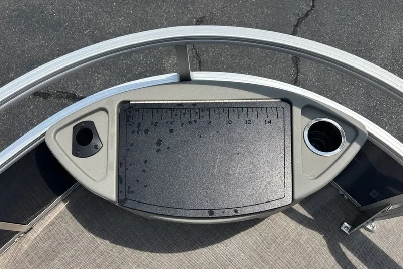Slide: The Image of 2024 Sun Tracker Bass Buggy 18 DLX fishing station with ruler and cup holder. - 25