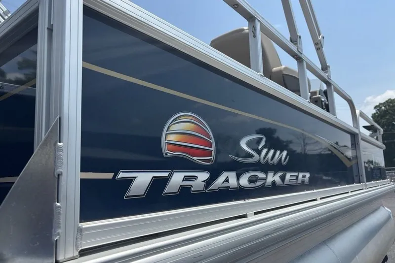 Slide: The Image of 2024 Sun Tracker Bass Buggy 18 DLX pontoon boat with logo detail. - 17