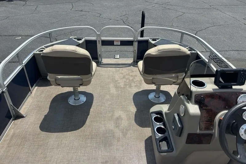 Slide: The Image of 2024 Sun Tracker Bass Buggy 18 DLX pontoon boat interior with seating and console. - 16
