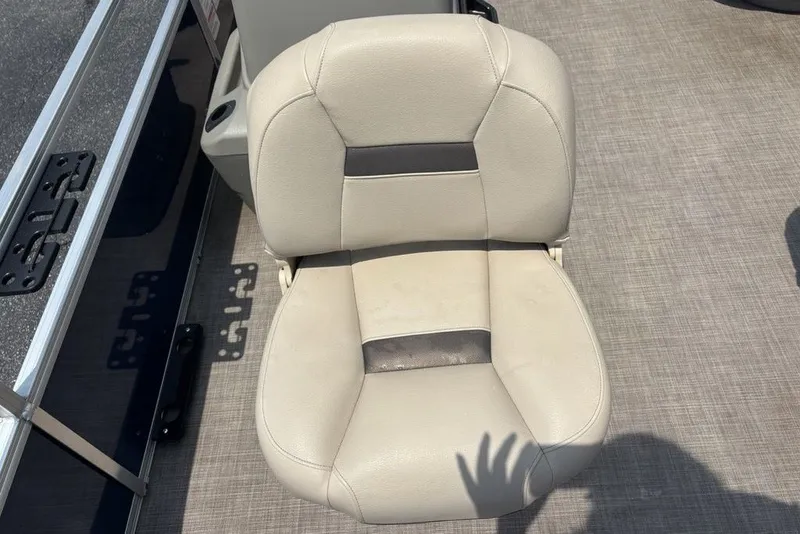 Slide: The Image of 2024 Sun Tracker Bass Buggy 18 DLX boat seat, beige upholstery, shadow on deck. - 22
