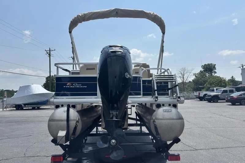 Slide: The Image of 2024 Sun Tracker Bass Buggy 18 DLX pontoon boat with outboard motor, rear view. - 15