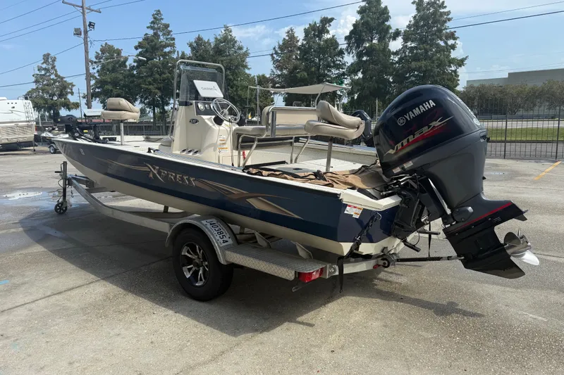 Slide: The Image of 2018 Express 20 boat with Yamaha engine on trailer, parked outdoors. - 7