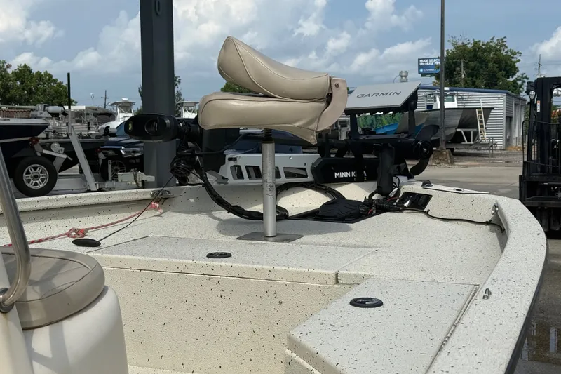 Slide: The Image of 2018 Express 20 boat with Garmin and Minn Kota equipment at a marina. - 16
