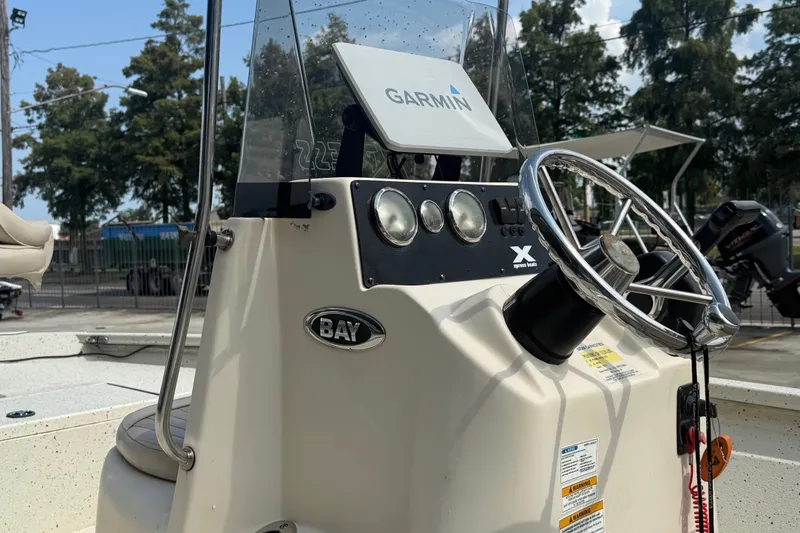 Slide: The Image of 2018 Express 20 boat console with Garmin navigation, steering wheel, and control panel. - 17