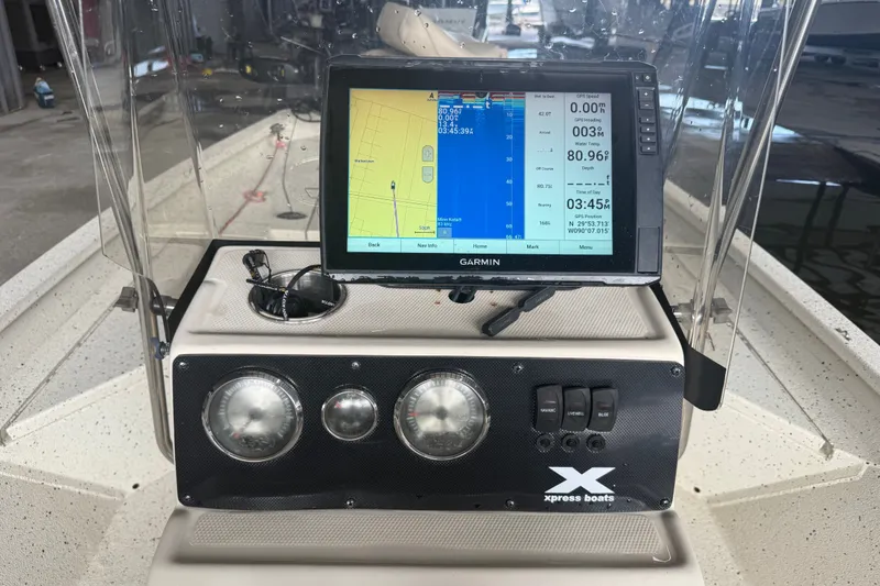 Slide: The Image of Console of a 2018 Express 20 boat featuring a Garmin GPS system. - 20