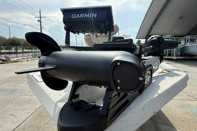 Slide: The Image of 2018 Express 20 boat with Garmin and Minn Kota accessories, docked outdoors. - 12