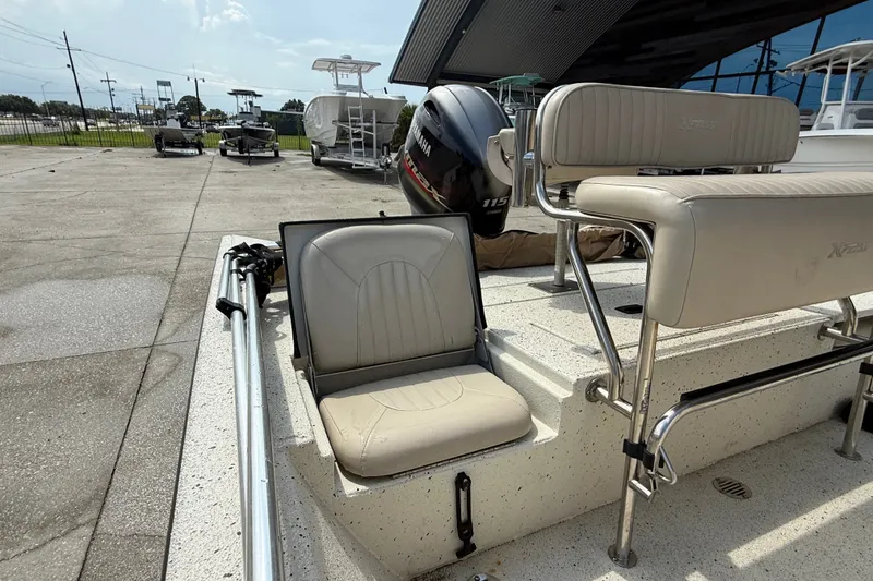 Slide: The Image of 2018 Express 20 boat with beige seating and Yamaha outboard motor in a parking area. - 14
