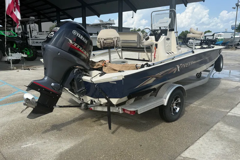 Slide: The Image of 2018 Express 20 boat with Yamaha outboard motor on trailer in marina setting. - 4